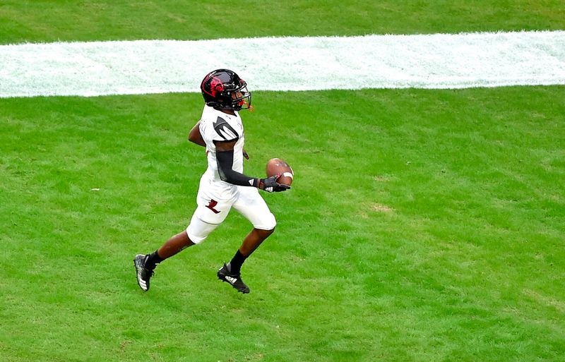 Nov 9, 2019; Miami Gardens, FL, USA; Louisville Cardinals wide receiver Tutu Atwell (1) scores a touchdown against the Miami Hurricanes during the first half at Hard Rock Stadium. Mandatory Credit: Steve Mitchell-USA TODAY Sports