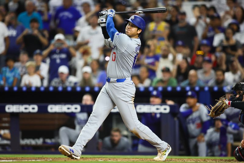 Sep 19, 2024; Miami, Florida, USA; Los Angeles Dodgers designated hitter Shohei Ohtani (17) hits a two-run home run against the Miami Marlins during the seventh inning at loanDepot Park. Mandatory Credit: Sam Navarro-Imagn Images