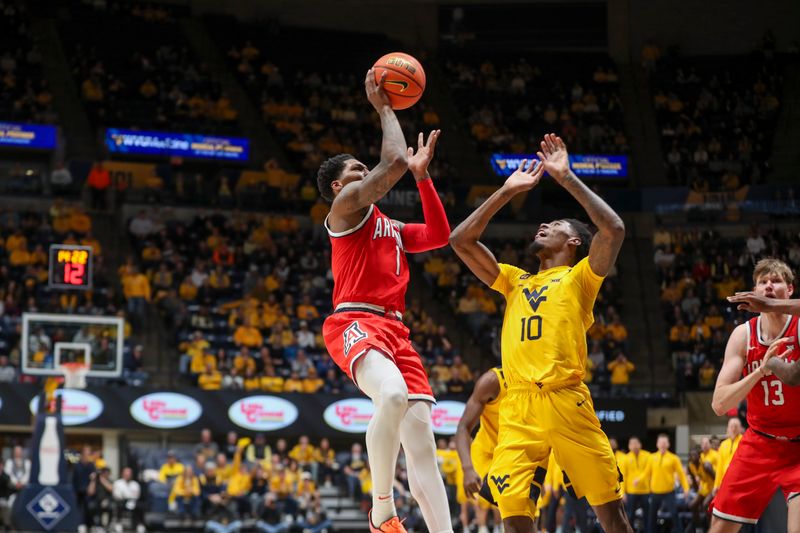 Jan 7, 2025; Morgantown, West Virginia, USA; West Virginia Mountaineers guard Joseph Yesufu (1) shoots against West Virginia Mountaineers guard Sencire Harris (10) during the second half at WVU Coliseum. Mandatory Credit: Ben Queen-Imagn Images