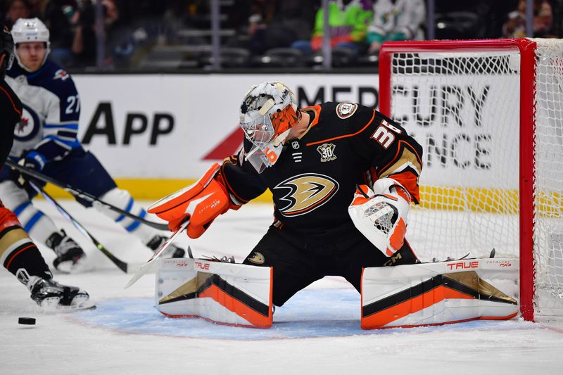 Jan 5, 2024; Anaheim, California, USA; Anaheim Ducks goaltender John Gibson (36) blocks a shot against the Winnipeg Jets during the first period at Honda Center. Mandatory Credit: Gary A. Vasquez-USA TODAY Sports