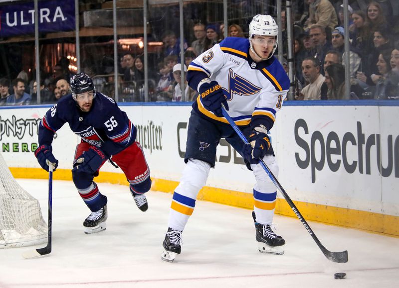 Mar 9, 2024; New York, New York, USA: St. Louis Blues right wing Alexei Toropchenko (13) plays the puck in front of New York Rangers defenseman Erik Gustafsson (56) during the first period at Madison Square Garden. Mandatory Credit: Danny Wild-USA TODAY Sports