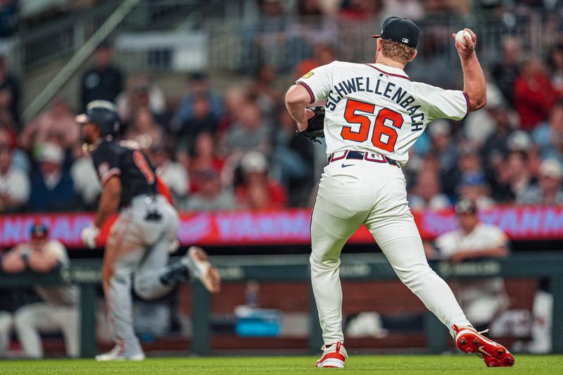 May 13, 2025; Cumberland, Georgia, USA; Atlanta Braves starting pitcher Spencer Schwellenbach (56) throws out Washington Nationals third baseman Jose Tena (8) after fielding a ground ball during the seventh inning at Truist Park. Mandatory Credit: Dale Zanine-Imagn Images