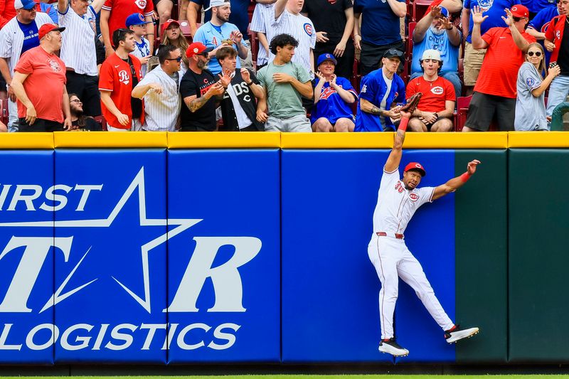 May 25, 2025; Cincinnati, Ohio, USA; Cincinnati Reds outfielder Will Benson (30) attempts to catch a solo home run hit by Chicago Cubs catcher Reese McGuire (20) in the second inning at Great American Ball Park. Mandatory Credit: Katie Stratman-Imagn Images