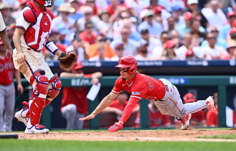 Aug 30, 2023; Philadelphia, Pennsylvania, USA; Los Angeles Angels shortstop Andrew Velazquez (4) dives home to score against the Philadelphia Phillies in the fifth inning at Citizens Bank Park. Mandatory Credit: Kyle Ross-USA TODAY Sports