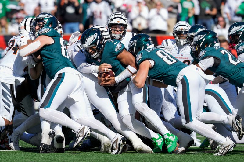 Philadelphia Eagles quarterback Jalen Hurts, center pushes for a first down carry against the Cincinnati Bengals during the first half of an NFL football game, Sunday, Oct. 27, 2024 in Cincinnati. (AP Photo/Jeff Dean)