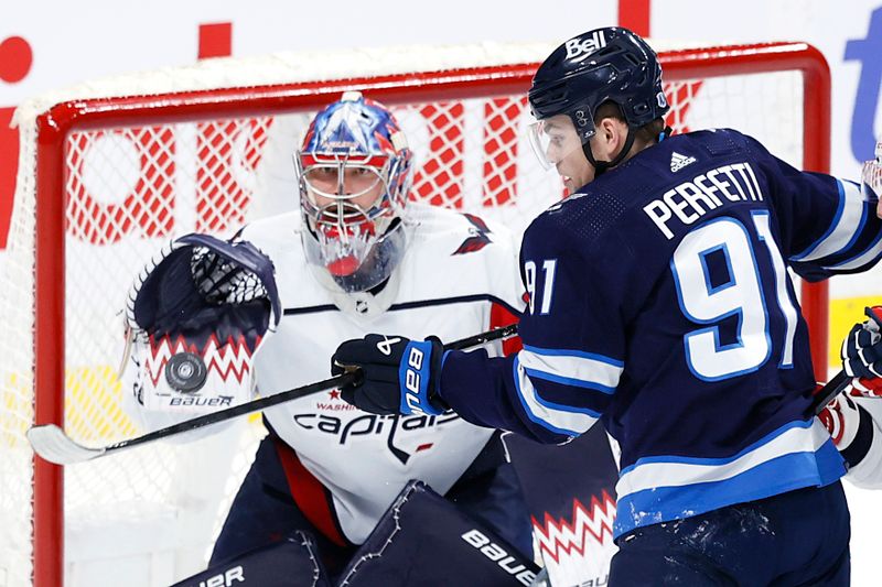 Mar 11, 2024; Winnipeg, Manitoba, CAN; Winnipeg Jets center Cole Perfetti (91) tries a tip in on Washington Capitals goaltender Charlie Lindgren (79) in the third period at Canada Life Centre. Mandatory Credit: James Carey Lauder-USA TODAY Sports