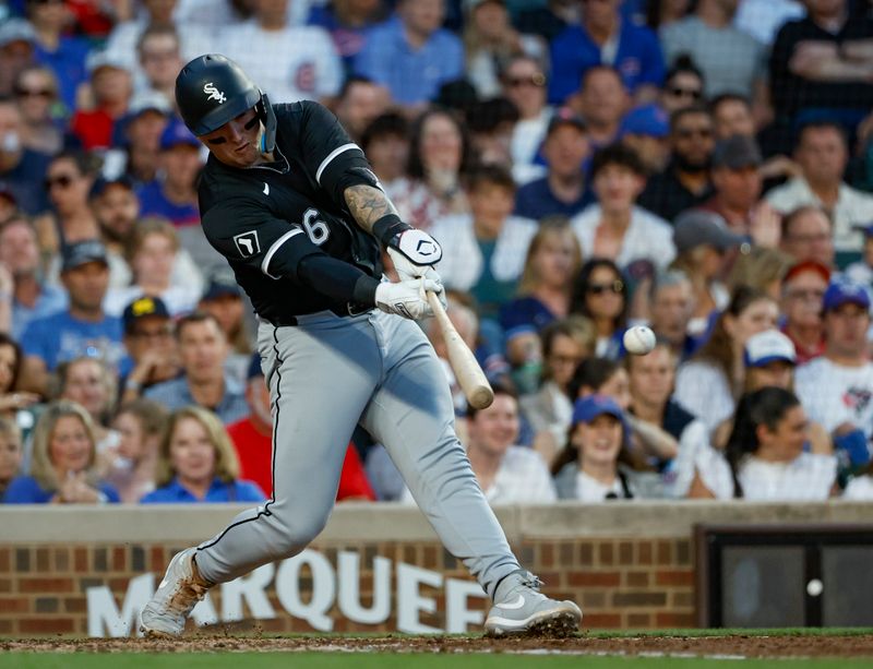 Jun 5, 2024; Chicago, Illinois, USA; Chicago White Sox catcher Korey Lee (26) hits an RBI-single against the Chicago Cubs during the fourth inning at Wrigley Field. Mandatory Credit: Kamil Krzaczynski-USA TODAY Sports