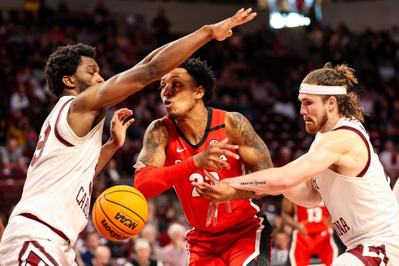 Mar 4, 2023; Columbia, South Carolina, USA; South Carolina Gamecocks forward Josh Gray (33) and forward Hayden Brown (10) battle Georgia Bulldogs center Braelen Bridges (23) for the ball in the second half at Colonial Life Arena. Mandatory Credit: Jeff Blake-USA TODAY Sports