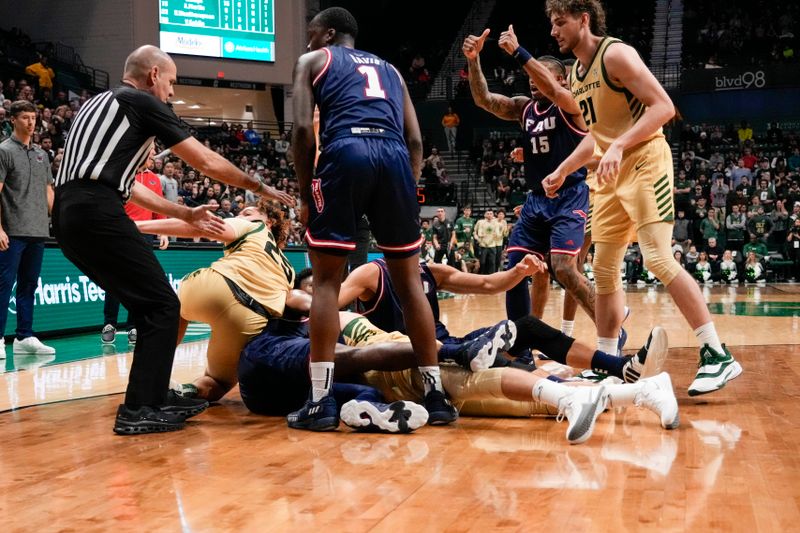 Jan 6, 2024; Charlotte, North Carolina, USA;  Players from Florida Atlantic Owls and Charlotte 49ers scrum for the loose ball late during the second half at Dale F. Halton Arena. Mandatory Credit: Jim Dedmon-USA TODAY Sports