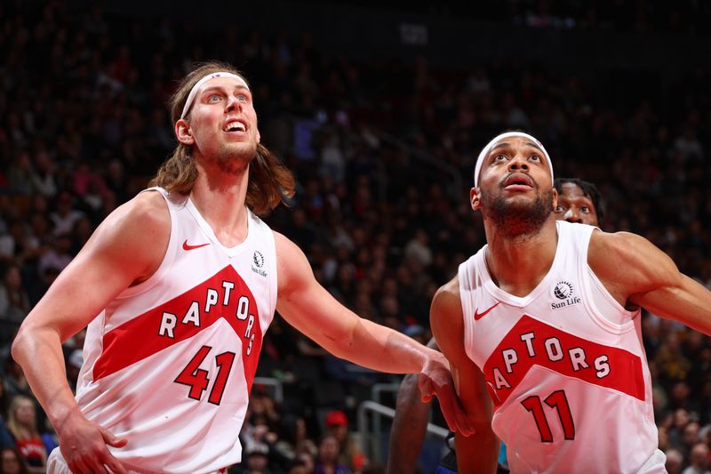 TORONTO, CANADA - MARCH 25: Kelly Olynyk #41 and Bruce Brown #11 of the Toronto Raptors look on during the game against the Brooklyn Nets on March 25, 2024 at the Scotiabank Arena in Toronto, Ontario, Canada.  NOTE TO USER: User expressly acknowledges and agrees that, by downloading and or using this Photograph, user is consenting to the terms and conditions of the Getty Images License Agreement.  Mandatory Copyright Notice: Copyright 2024 NBAE (Photo by Vaughn Ridley/NBAE via Getty Images)