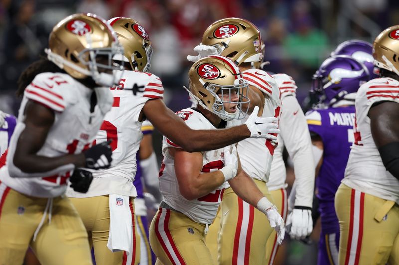 San Francisco 49ers running back Christian McCaffrey (23) celebrates with teammates after scoring a touchdown during the second half of an NFL football game against the Minnesota Vikings, Monday, Oct. 23, 2023 in Minneapolis. (AP Photo/Stacy Bengs)