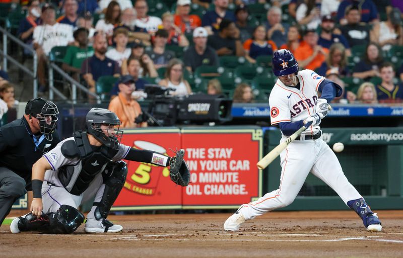 Jun 25, 2024; Houston, Texas, USA; Houston Astros third baseman Alex Bregman (2) hits a RBI single against the Colorado Rockies in the first inning at Minute Maid Park. Mandatory Credit: Thomas Shea-USA TODAY Sports