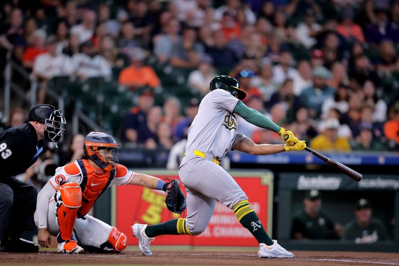 May 14, 2024; Houston, Texas, USA; Oakland Athletics third baseman Abraham Toro (31) hits a single against the Houston Astros during the first inning at Minute Maid Park. Mandatory Credit: Erik Williams-USA TODAY Sports