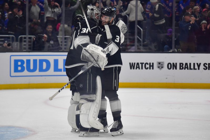 Jan 20, 2024; Los Angeles, California, USA; Los Angeles Kings defenseman Matt Roy (3) and goaltender David Rittich (31) celebrate the victory against the New York Rangers at Crypto.com Arena. Mandatory Credit: Gary A. Vasquez-USA TODAY Sports