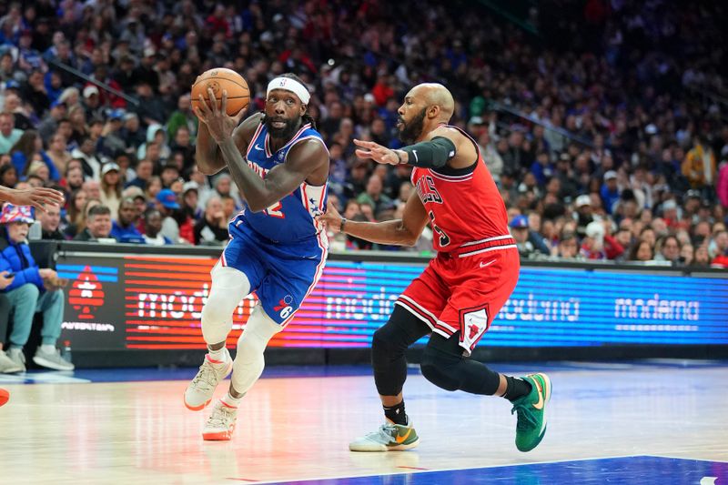 PHILADELPHIA, PENNSYLVANIA - JANUARY 2: Patrick Beverley #22 of the Philadelphia 76ers drives to the basket against Jevon Carter #5 of the Chicago Bulls at the Wells Fargo Center on January 2, 2024 in Philadelphia, Pennsylvania. The 76ers defeated the Bulls 110-97. NOTE TO USER: User expressly acknowledges and agrees that, by downloading and or using this photograph, User is consenting to the terms and conditions of the Getty Images License Agreement. (Photo by Mitchell Leff/Getty Images)