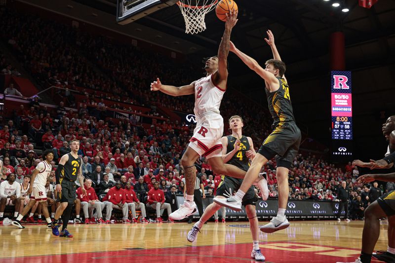 Feb 12, 2025; Piscataway, New Jersey, USA; Rutgers Scarlet Knights guard Dylan Harper (2) goes to the basket against Iowa Hawkeyes forward Pryce Sandfort (24) during the second half at Jersey Mike's Arena. Mandatory Credit: Vincent Carchietta-Imagn Images