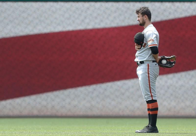 Jul 16, 2023; Pittsburgh, Pennsylvania, USA; San Francisco Giants third baseman J.D. Davis (7) stands for the playing of the National Anthem against the Pittsburgh Pirates at PNC Park. Mandatory Credit: Charles LeClaire-USA TODAY Sports