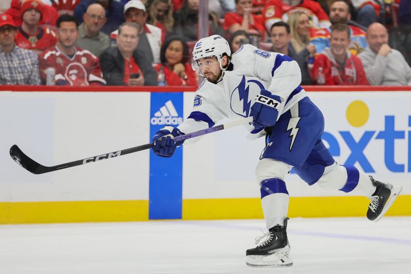 Apr 23, 2024; Sunrise, Florida, USA; Tampa Bay Lightning defenseman Maxwell Crozier (65)  shoots the puck against the Florida Panthers during the first period in game two of the first round of the 2024 Stanley Cup Playoffs at Amerant Bank Arena. Mandatory Credit: Sam Navarro-USA TODAY Sports