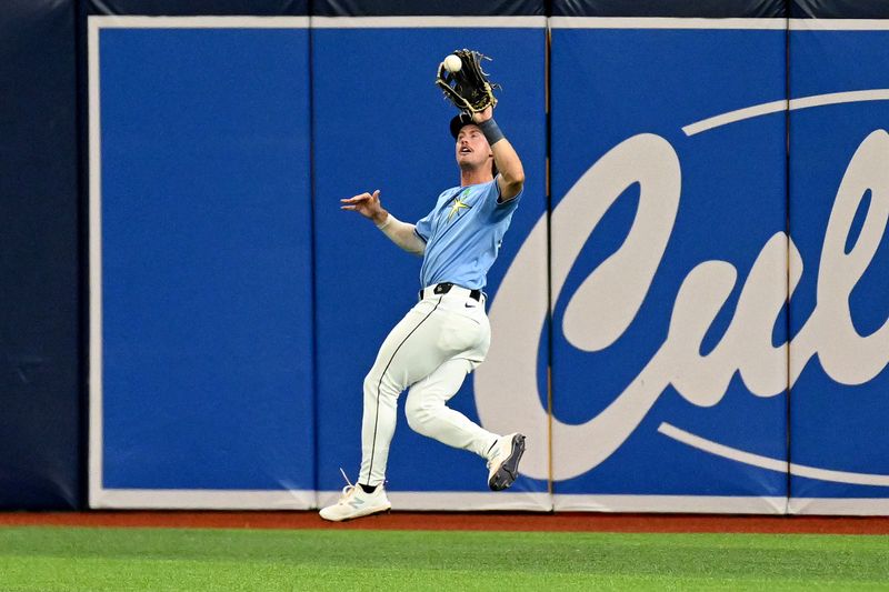 May 26, 2024; St. Petersburg, Florida, USA; Tampa Bay Rays right fielder Jonny DeLuca (21) catches a line drive in the eighth inning against the Kansas City Royals at Tropicana Field. Mandatory Credit: Jonathan Dyer-USA TODAY Sports