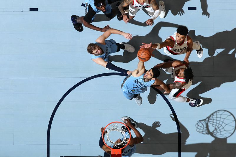 MEMPHIS, TN - MARCH 2: Santi Aldama #7 of the Memphis Grizzlies grabs a rebound during the game against the Portland Trail Blazers on March 2, 2024 at FedExForum in Memphis, Tennessee. NOTE TO USER: User expressly acknowledges and agrees that, by downloading and or using this photograph, User is consenting to the terms and conditions of the Getty Images License Agreement. Mandatory Copyright Notice: Copyright 2024 NBAE (Photo by Joe Murphy/NBAE via Getty Images)