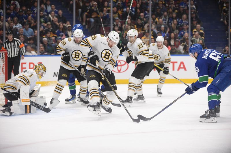 Feb 24, 2024; Vancouver, British Columbia, CAN;  Vancouver Canucks forward Ilya Mikheyev (65) shoots the puck against Boston Bruins defenseman Derek Forbort (28) and goaltender Jeremy Swayman (1) during the third period at Rogers Arena. Mandatory Credit: Anne-Marie Sorvin-USA TODAY Sports