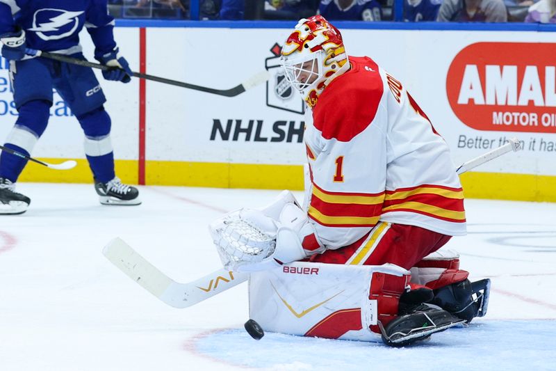 Nov 26, 2025; Tampa, Florida, USA; Calgary Flames goaltender Devin Cooley (1) makes a save against the Tampa Bay Lightning in the third period at Benchmark International Arena. Mandatory Credit: Nathan Ray Seebeck-Imagn Images