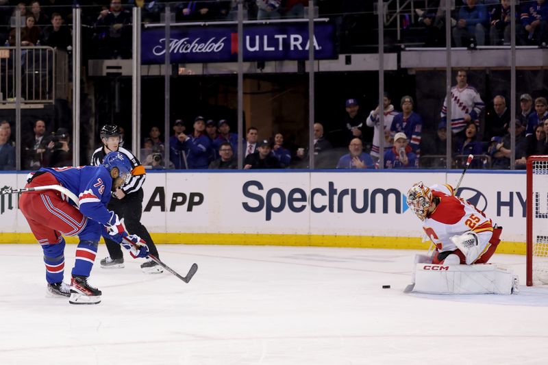 Feb 12, 2024; New York, New York, USA; New York Rangers defenseman K'Andre Miller (79) takes a shot against Calgary Flames goaltender Jacob Markstrom (25) during the third period at Madison Square Garden. Mandatory Credit: Brad Penner-USA TODAY Sports