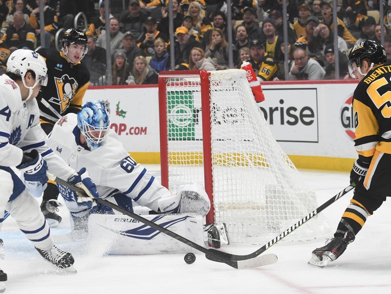 Nov 25, 2023; Pittsburgh, Pennsylvania, USA; Toronto Maple Leafs goalie Joseph Woll (60) stops Pittsburgh Penguins left wing Jake Guentzel (59) during the first period at PPG Paints Arena. Mandatory Credit: Philip G. Pavely-USA TODAY Sports