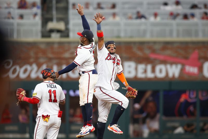 Jun 27, 2023; Atlanta, Georgia, USA; Atlanta Braves second baseman Ozzie Albies (1) and right fielder Ronald Acuna Jr. (13) celebrate after a victory against the Minnesota Twins at Truist Park. Mandatory Credit: Brett Davis-USA TODAY Sports