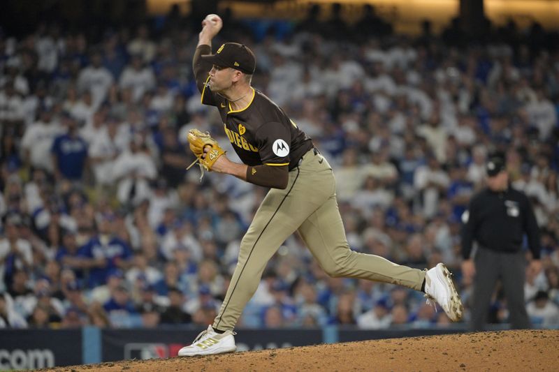 Oct 11, 2024; Los Angeles, California, USA; San Diego Padres pitcher Jason Adam (40) pitches in the eighth inning against the Los Angeles Dodgers during game five of the NLDS for the 2024 MLB Playoffs at Dodger Stadium. Mandatory Credit: Jayne Kamin-Oncea-Imagn Images