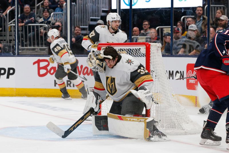 Mar 4, 2024; Columbus, Ohio, USA; Vegas Golden Knights goalie Adin Hill (33) loses his mask after making a save on a Columbus Blue Jackets shot attempt during the second period at Nationwide Arena. Mandatory Credit: Russell LaBounty-USA TODAY Sports