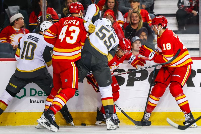 Dec 20, 2025; Calgary, Alberta, CAN; Calgary Flames left wing Ryan Lomberg (70) and Vegas Golden Knights right wing Keegan Kolesar (55) battle for the puck during the second period at Scotiabank Saddledome. Mandatory Credit: Sergei Belski-Imagn Images