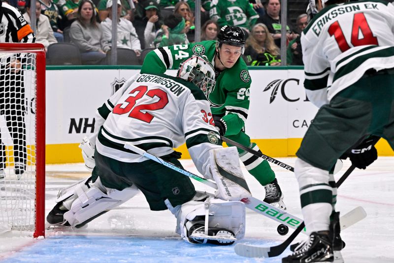 Oct 14, 2025; Dallas, Texas, USA; Minnesota Wild goaltender Filip Gustavsson (32) stops a shot in front of Dallas Stars center Roope Hintz (24) during the second period at the American Airlines Center. Mandatory Credit: Jerome Miron-Imagn Images