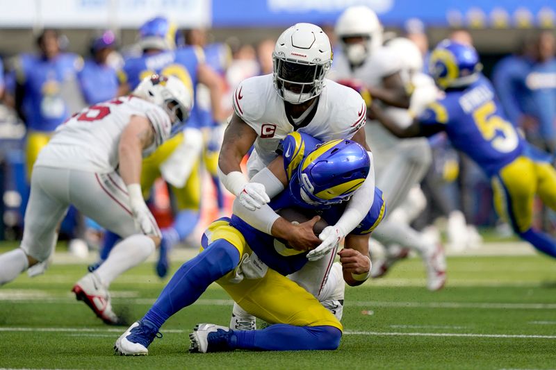 Arizona Cardinals linebacker Kyzir White (7) sacks Los Angeles Rams quarterback Matthew Stafford (9) during the first half of an NFL football game Sunday, Oct. 15, 2023, in Inglewood, Calif. (AP Photo/Ryan Sun)