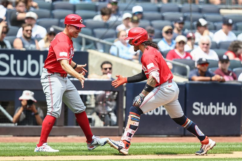 Jul 4, 2024; Bronx, New York, USA; Cincinnati Reds second baseman Jonathan India (6) celebrates with third base coach J.R. House (56) after hitting a solo home run in the third inning against the New York Yankees at Yankee Stadium. Mandatory Credit: Wendell Cruz-USA TODAY Sports