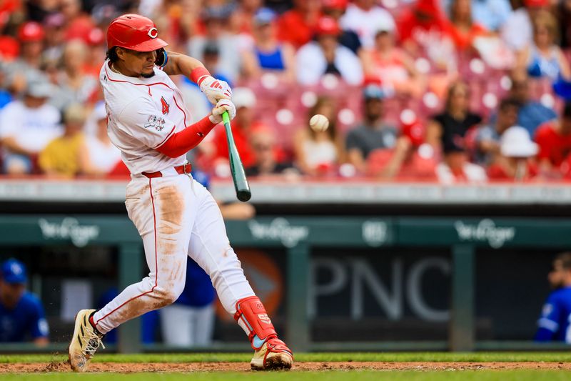 Aug 18, 2024; Cincinnati, Ohio, USA; Cincinnati Reds third baseman Santiago Espinal (4) hits a single in the fifth inning against the Kansas City Royals at Great American Ball Park. Mandatory Credit: Katie Stratman-USA TODAY Sports