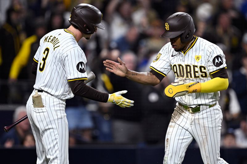 Apr 20, 2024; San Diego, California, USA; San Diego Padres left fielder Jose Azocar (28) is congratulated by center fielder Jackson Merrill (3) after scoring a run against the Toronto Blue Jays during the eighth inning at Petco Park. Mandatory Credit: Orlando Ramirez-USA TODAY Sports