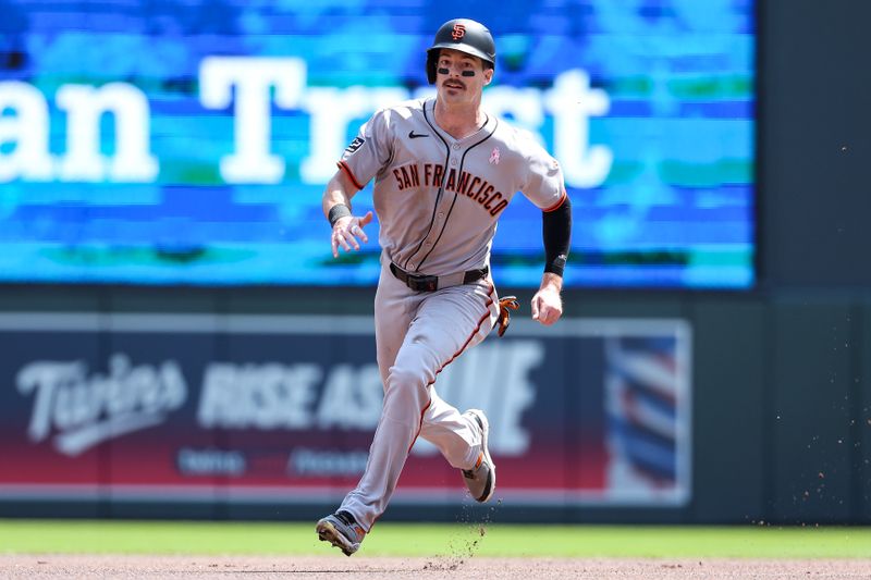 May 11, 2025; Minneapolis, Minnesota, USA; San Francisco Giants right fielder Mike Yastrzemski (5) advances to third base on a single hit by designated hitter Jung Hoo Lee (51)  during the first inning at Target Field. Mandatory Credit: Matt Krohn-Imagn Images