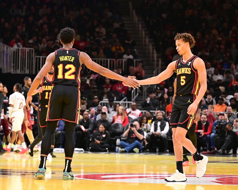 ATLANTA, GA - NOVEMBER 29: De'Andre Hunter #12 and Dyson Daniels #5 of the Atlanta Hawks high five during the game against the Cleveland Cavaliers on November 29, 2024 at State Farm Arena in Atlanta, Georgia.  NOTE TO USER: User expressly acknowledges and agrees that, by downloading and/or using this Photograph, user is consenting to the terms and conditions of the Getty Images License Agreement. Mandatory Copyright Notice: Copyright 2024 NBAE (Photo by Adam Hagy/NBAE via Getty Images)