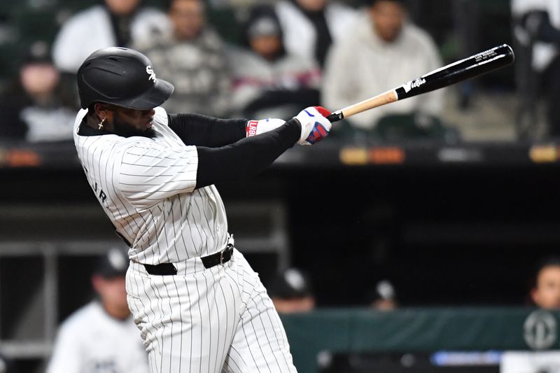 Apr 2, 2024; Chicago, Illinois, USA; Chicago White Sox center fielder Luis Robert Jr. (88) doubles during the eighth inning againnst the Atlanta Braves at Guaranteed Rate Field. Mandatory Credit: Patrick Gorski-USA TODAY Sports