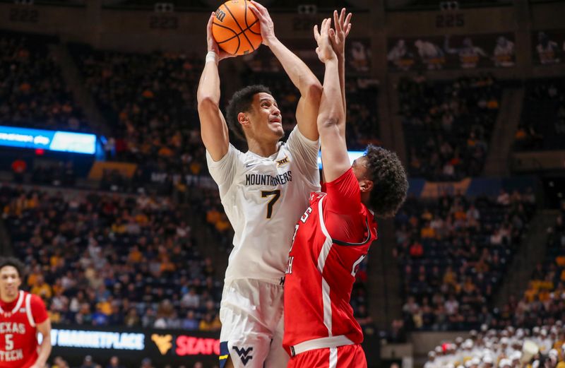 Mar 2, 2024; Morgantown, West Virginia, USA; West Virginia Mountaineers center Jesse Edwards (7) shoots over Texas Tech Red Raiders forward Eemeli Yalaho (23) during the second half at WVU Coliseum. Mandatory Credit: Ben Queen-USA TODAY Sports