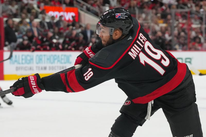 Mar 10, 2026; Raleigh, North Carolina, USA;  aCarolina Hurricanes defenseman K'andre Miller (19) takes a shot against the Pittsburgh Penguins during the first period t Lenovo Center. Mandatory Credit: James Guillory-Imagn Images