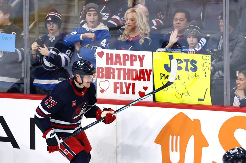 Feb 14, 2024; Winnipeg, Manitoba, CAN; Winnipeg Jets left wing Nikolaj Ehlers (27) skates past fans before a game against the San Jose Sharks at Canada Life Centre. Mandatory Credit: James Carey Lauder-USA TODAY Sports