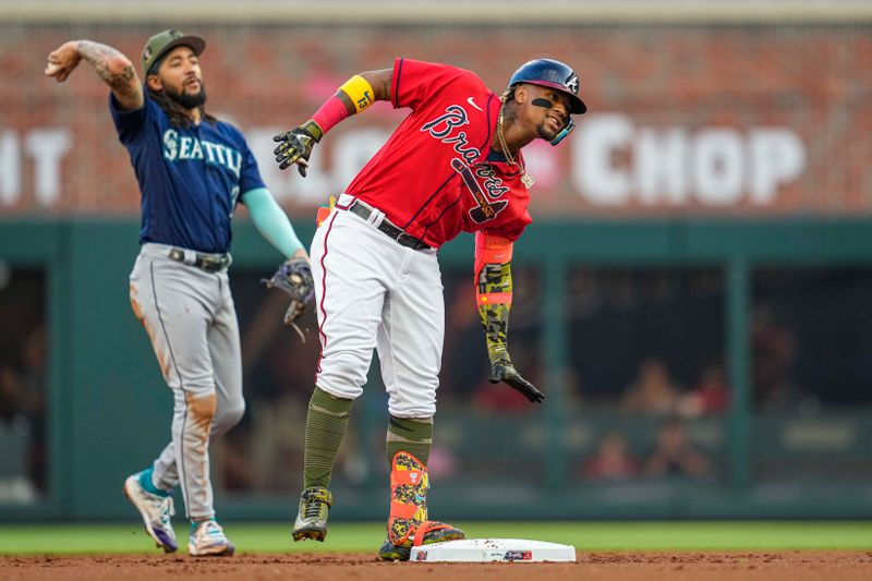 May 19, 2023; Cumberland, Georgia, USA; Atlanta Braves right fielder Ronald Acuna Jr. (13) reacts after hitting a double against the Seattle Mariners during the first inning at Truist Park. Mandatory Credit: Dale Zanine-USA TODAY Sports