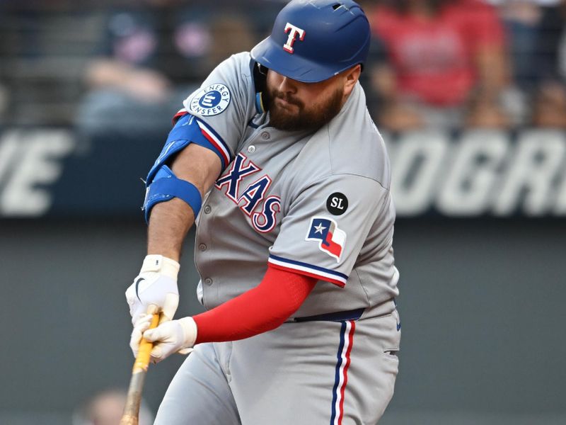 Sep 28, 2025; Cleveland, Ohio, USA;  Texas Rangers first baseman Jake Burger (21) hits a home run during the tenth inning against the Cleveland Guardians at Progressive Field. Mandatory Credit: Ken Blaze-Imagn Images