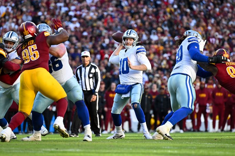 Dallas Cowboys quarterback Cooper Rush (10) throws a touchdown pass to wide receiver Jalen Tolbert, not pictured, during the second half of an NFL football game against the Washington Commanders, Sunday, Nov. 24, 2024, in Landover, Md. (AP Photo/Terrance Williams)