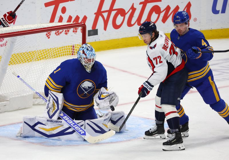 Nov 1, 2025; Buffalo, New York, USA;  Buffalo Sabres defenseman Bowen Byram (4) defends as Washington Capitals left wing Anthony Beauvillier (72) looks to deflect a shot on Buffalo Sabres goaltender Ukko-Pekka Luukkonen (1) during the third period at KeyBank Center. Mandatory Credit: Timothy T. Ludwig-Imagn Images