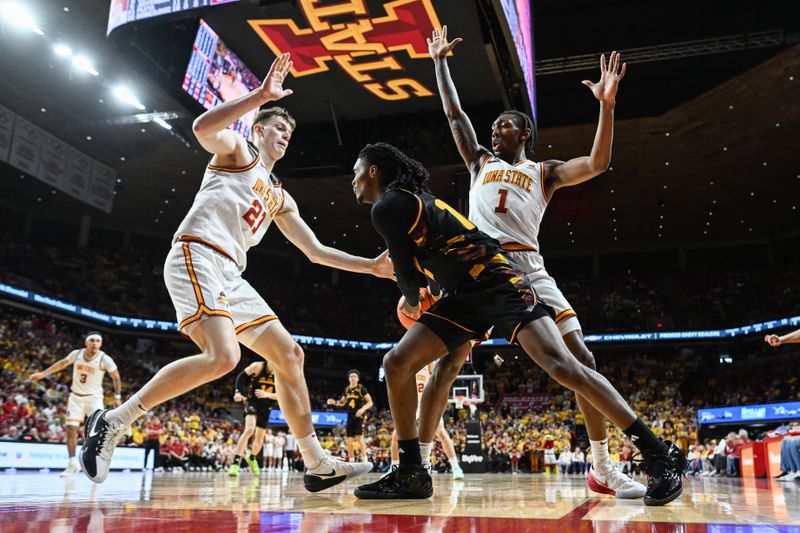 Mar 7, 2026; Ames, Iowa, USA; Arizona State Sun Devils guard Trevor Best (12) is defended by Iowa State Cyclones guard Jamarion Batemon (1) and forward Dominykas Pleta (21) during the second half at James H. Hilton Coliseum. Mandatory Credit: Jeffrey Becker-Imagn Images