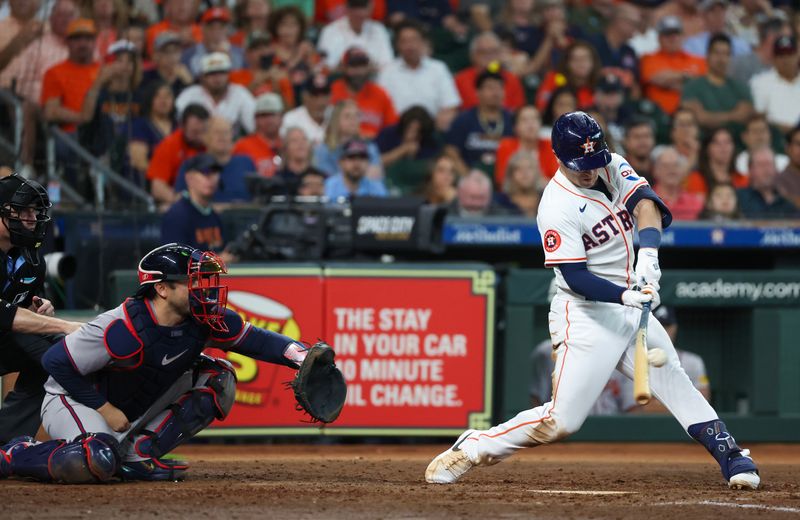 Apr 17, 2024; Houston, Texas, USA; Houston Astros third baseman Alex Bregman (2) hits a RBI single against the Atlanta Braves in the fifth inning at Minute Maid Park. Mandatory Credit: Thomas Shea-USA TODAY Sports