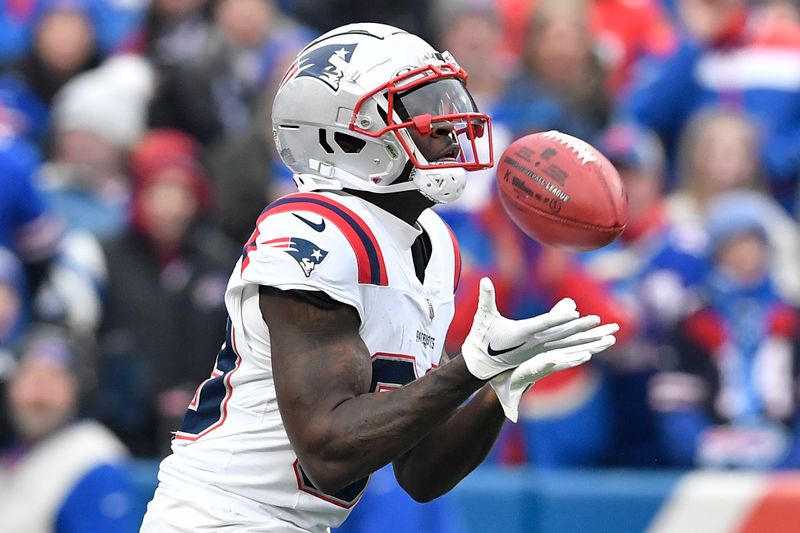 New England Patriots Jalen Reagor catches the kickoff by Buffalo Bills place kicker Tyler Bass (2) before returning it 98-yards for a touchdown during the first half of an NFL football game in Orchard Park, N.Y., Sunday, Dec. 31, 2023. (AP Photo/Adrian Kraus)